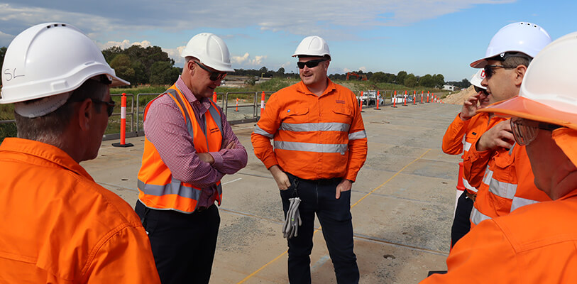 Minister for Regional Development and Manufacturing Glenn Butcher with workers at the QTMP Ormeau rail site, under construction.