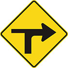 yellow diamond-shaped sign with black arrow that curves sharply right with a thinner line branching to the left
