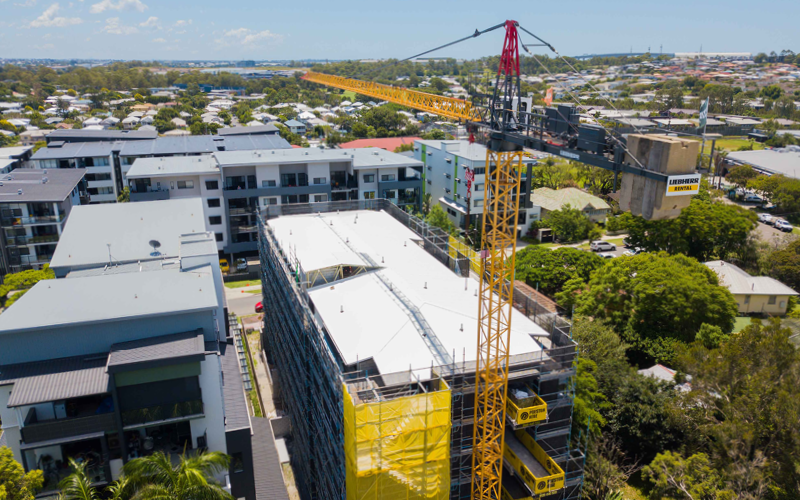 birdseye photo of a building construction with a crane