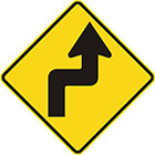 yellow diamond-shaped sign with black arrow that has tail bent at right angles right then left