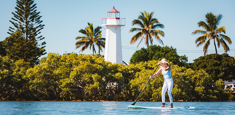 A woman enjoys paddle boarding