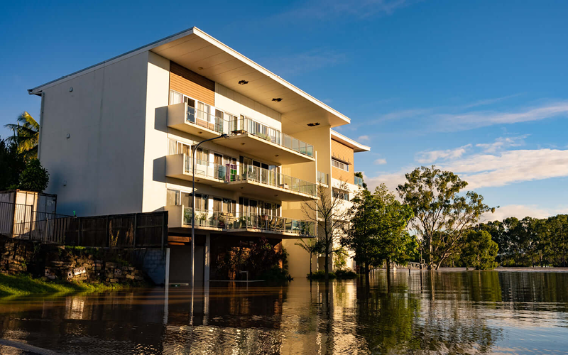 photo of apartment block surrounded by floodwater